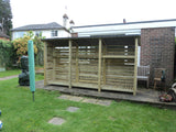 Very large slatted log store with felt roof and shelf