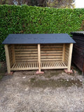 Large slatted log store with felt roof